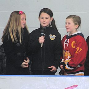 Jayden Maki (L) and Hailey and Annan Moffat sing O Canada before the Wolves and Lancers game at the Lucknow Arena Saturday night; photos by David Dadson